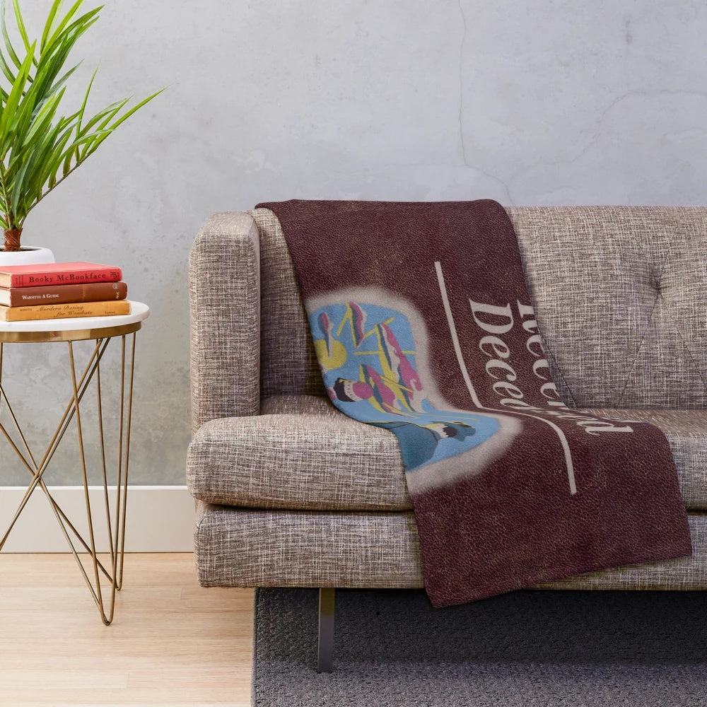 Beetlejuice-inspired plush blanket with "Handbook for the Recently Deceased" design