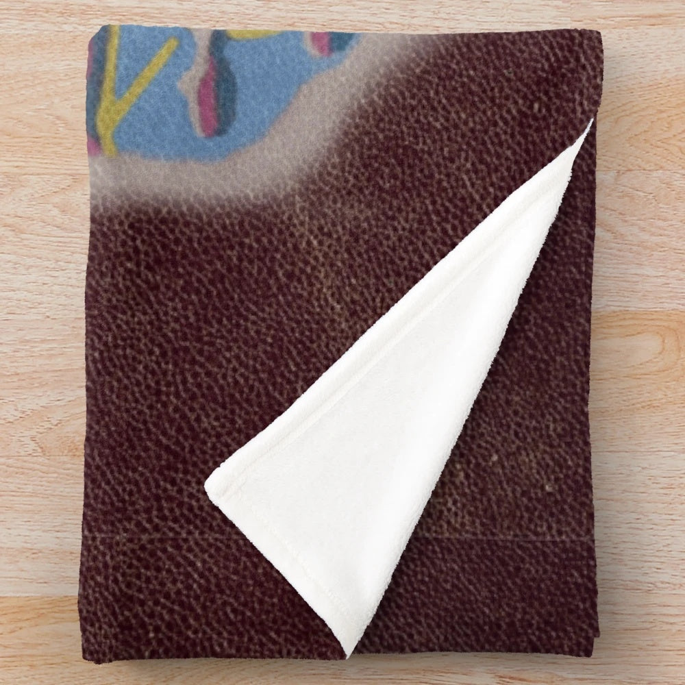 Beetlejuice-inspired plush blanket with "Handbook for the Recently Deceased" design