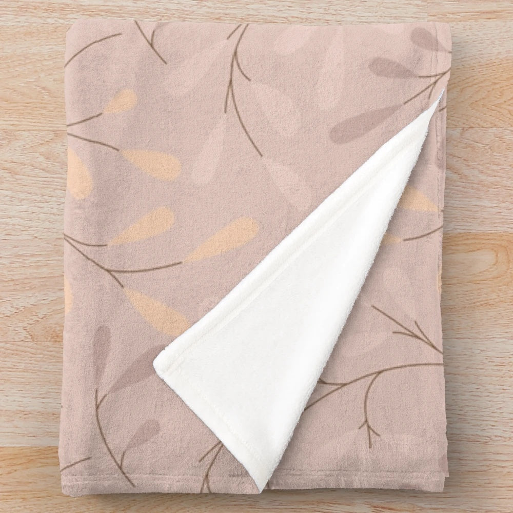 Beige plush blanket with leafy botanical design