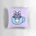 A black cat-themed throw pillow with a pastel goth, witchy design featuring a cat holding a cup of tea or coffee.