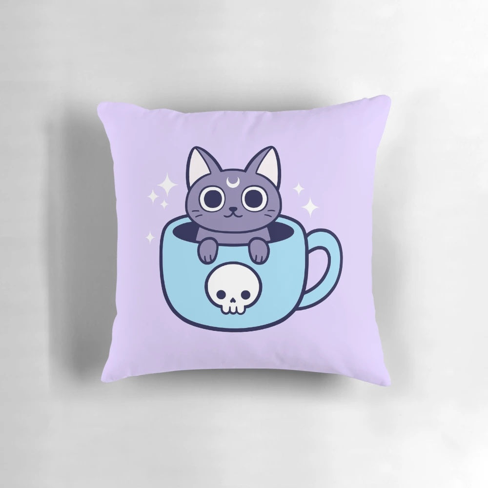 A black cat-themed throw pillow with a pastel goth, witchy design featuring a cat holding a cup of tea or coffee.