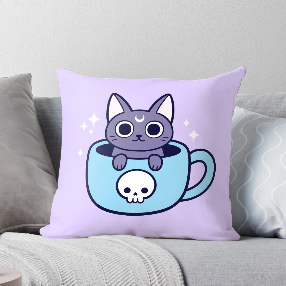 A black cat-themed throw pillow with a pastel goth, witchy design featuring a cat holding a cup of tea or coffee.