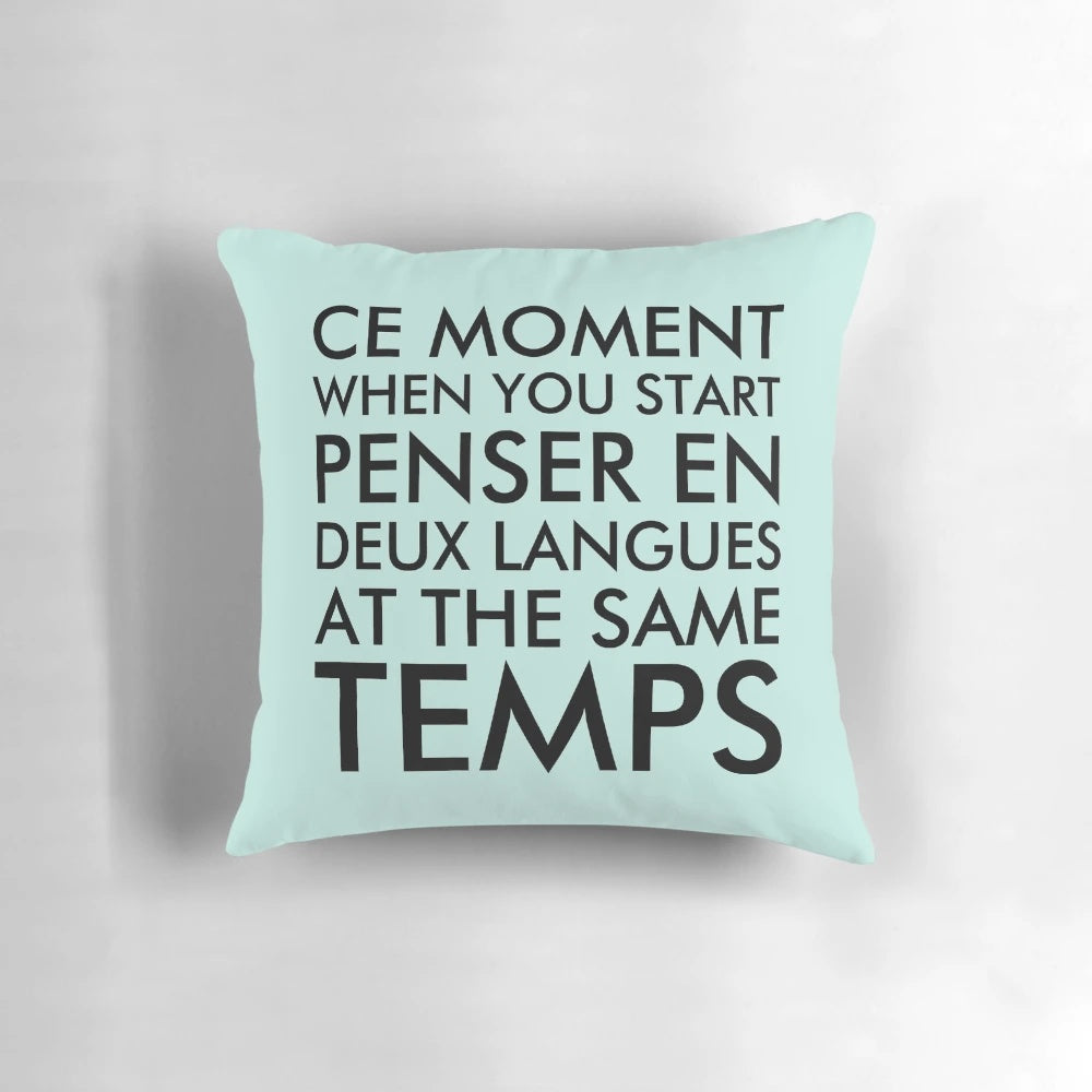 A black pillow with the text "Thinking in French and English" printed on it.