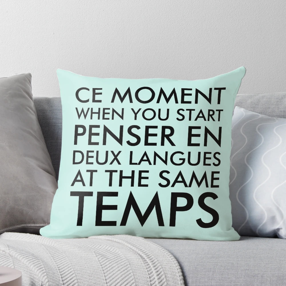 A black pillow with the text "Thinking in French and English" printed on it.