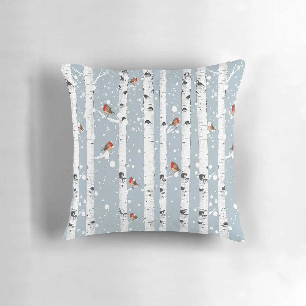 Cozy pillow featuring a snowy birch tree forest with a red-breasted robin bird, perfect for nature enthusiasts
