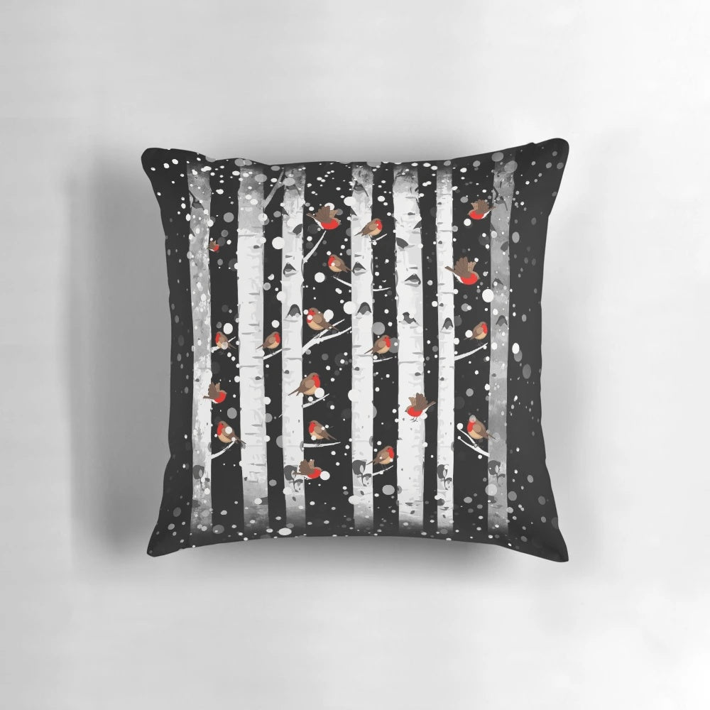 Pillow featuring a snowy forest scene with birch trees and a red-breasted bird