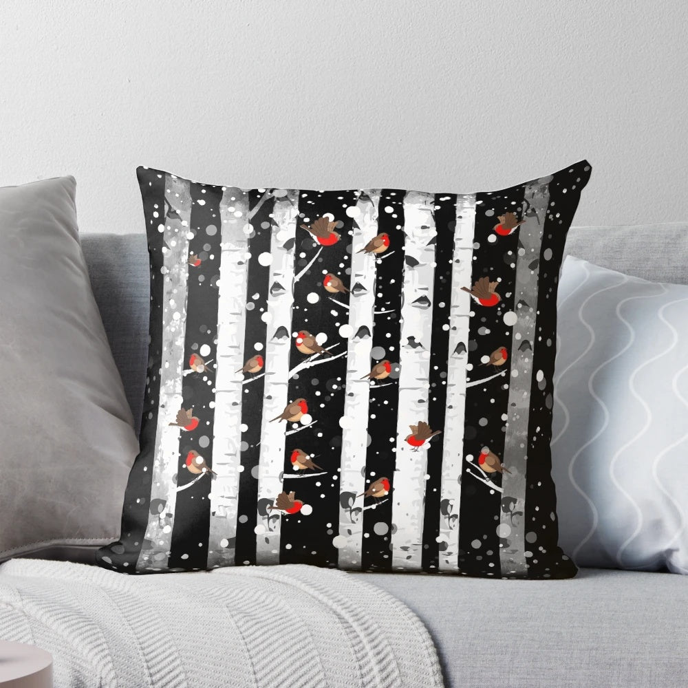 Pillow featuring a snowy forest scene with birch trees and a red-breasted bird