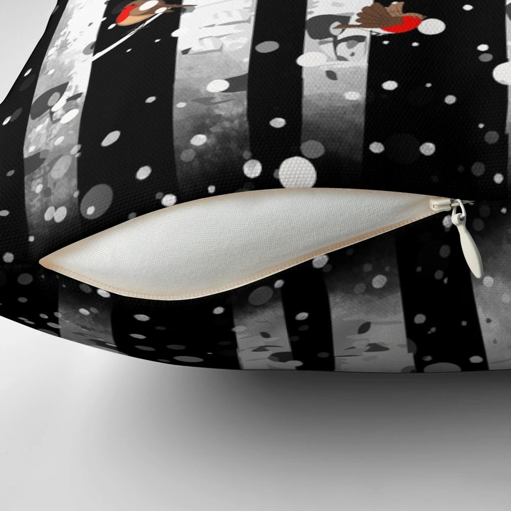 Pillow featuring a snowy forest scene with birch trees and a red-breasted bird