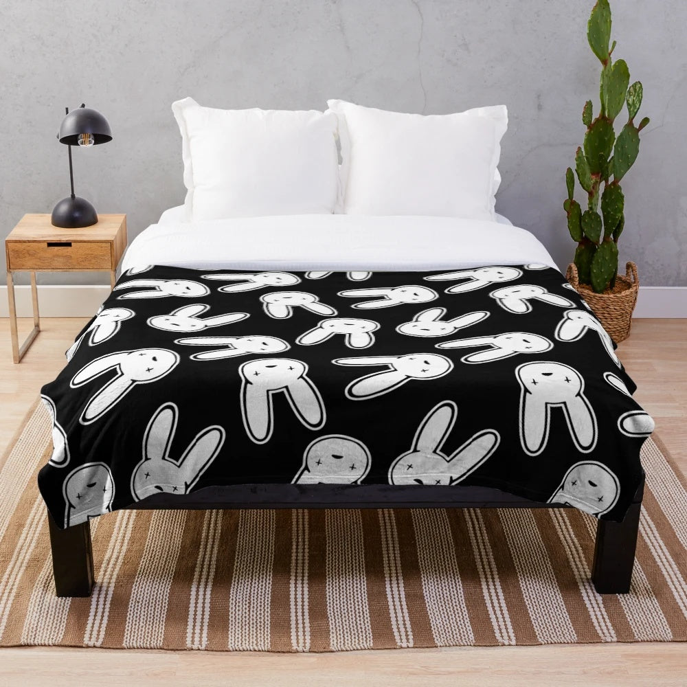 Black and white plush blanket featuring the Oasis logo design associated with Bad Bunny