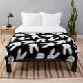 Black and white plush blanket featuring the Oasis logo design associated with Bad Bunny