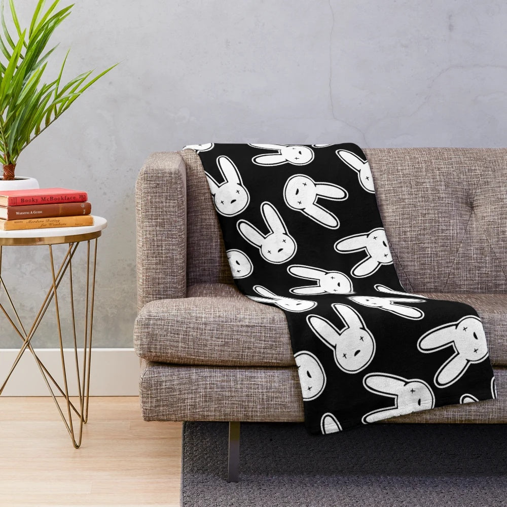 Black and white plush blanket featuring the Oasis logo design associated with Bad Bunny