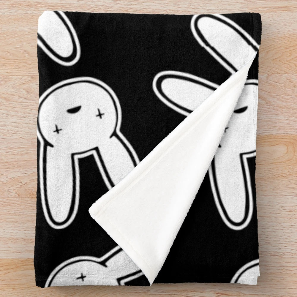 Black and white plush blanket featuring the Oasis logo design associated with Bad Bunny