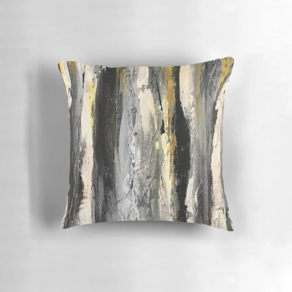 A modern, minimalist black and white pillow featuring an abstract design of birch trees.