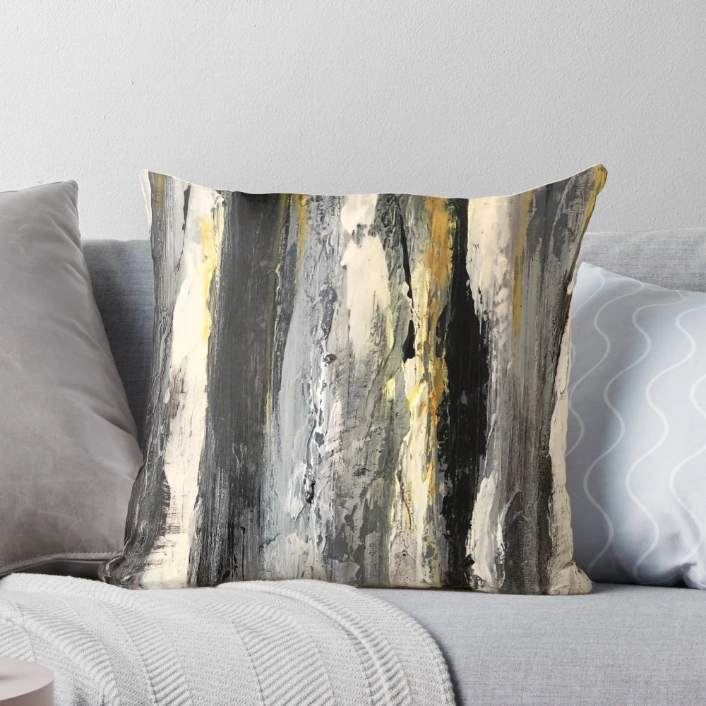 A modern, minimalist black and white pillow featuring an abstract design of birch trees.