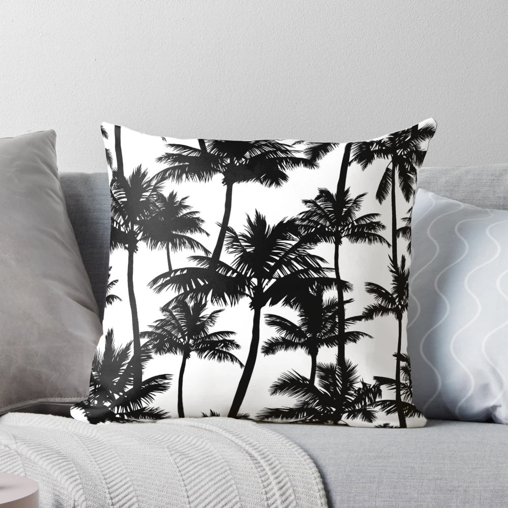 A black and white pillow cover featuring a pattern of detailed palm tree silhouettes against a plain white background.