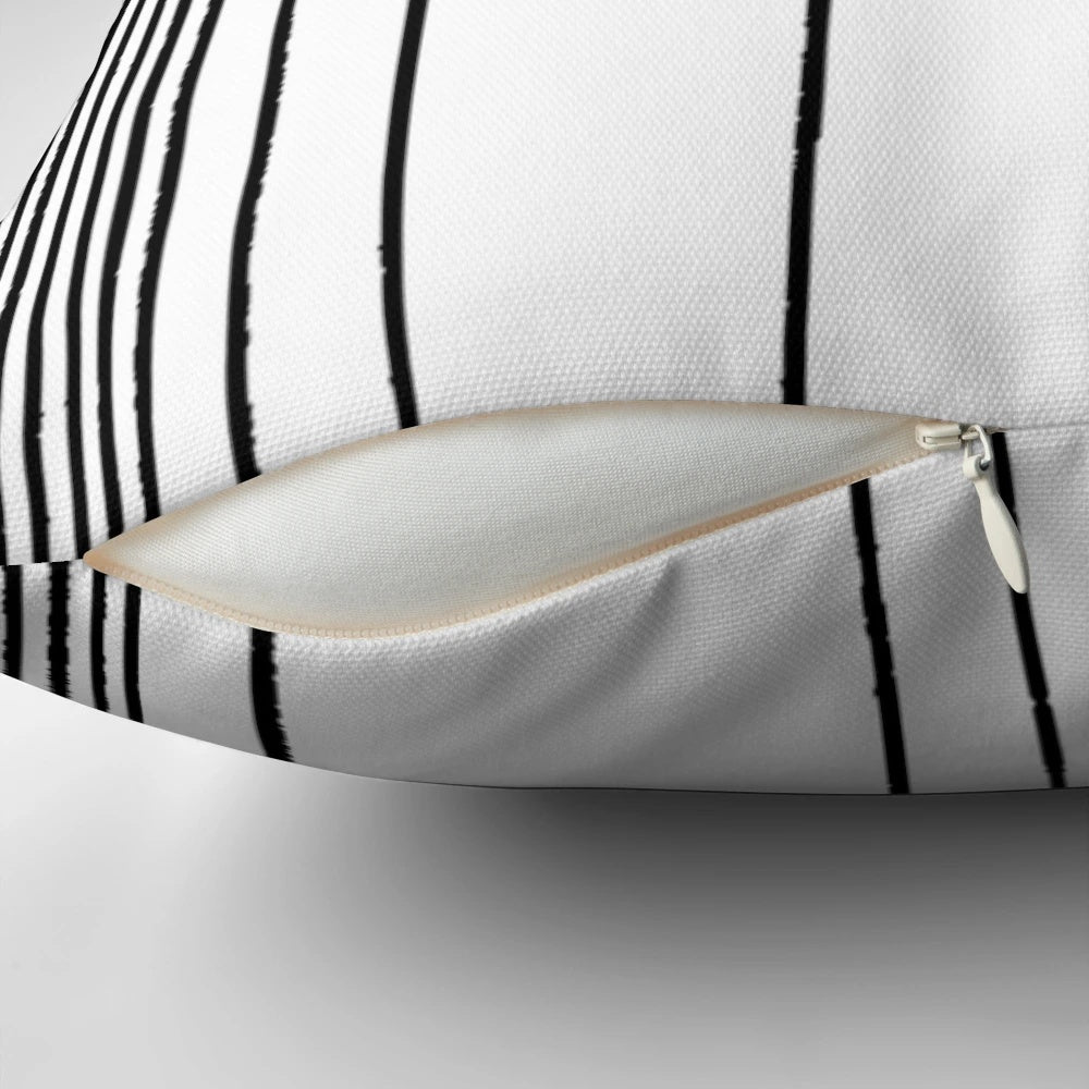 Black and white graphic design inspired by The Umbrella Academy logo on a decorative throw pillow