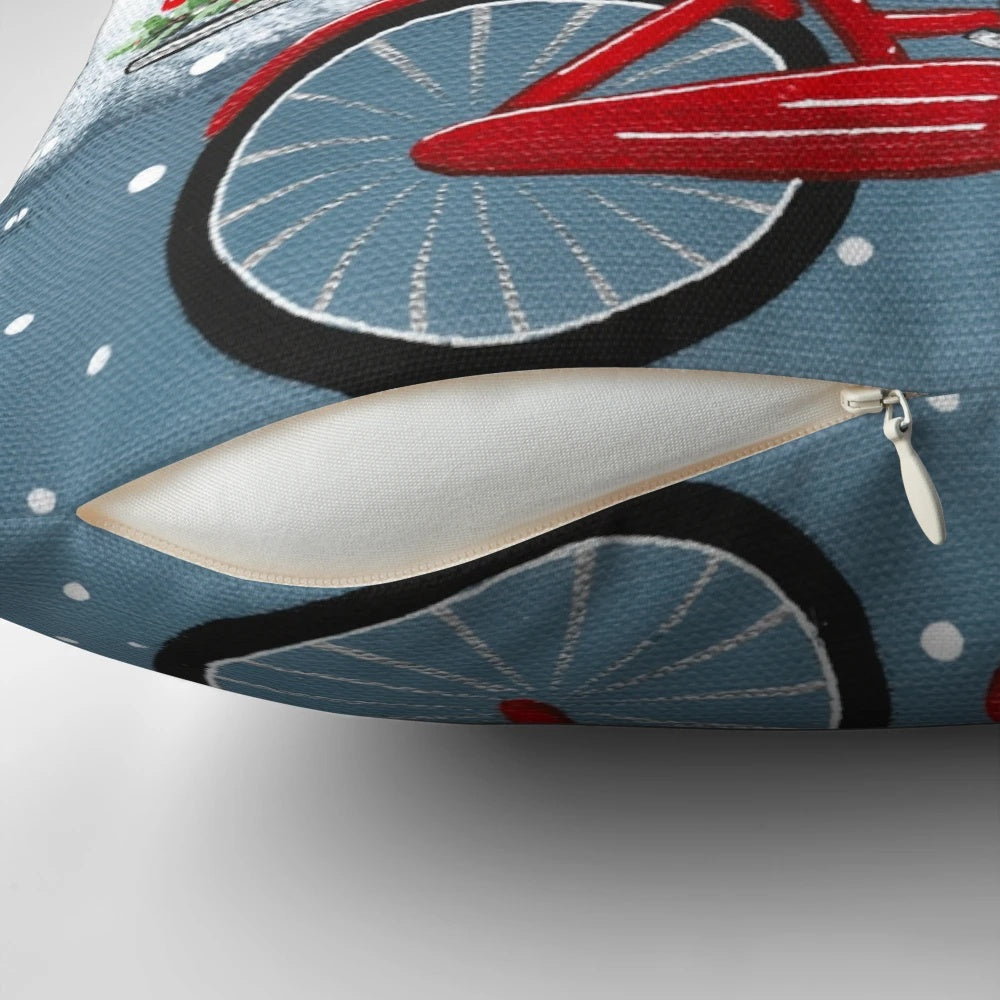 Black cat riding a bicycle with Christmas decorations on a pillow