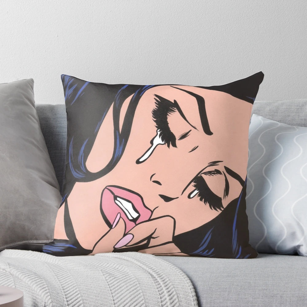 Black and white comic-style illustration of a crying woman with black hair on a decorative throw pillow.
