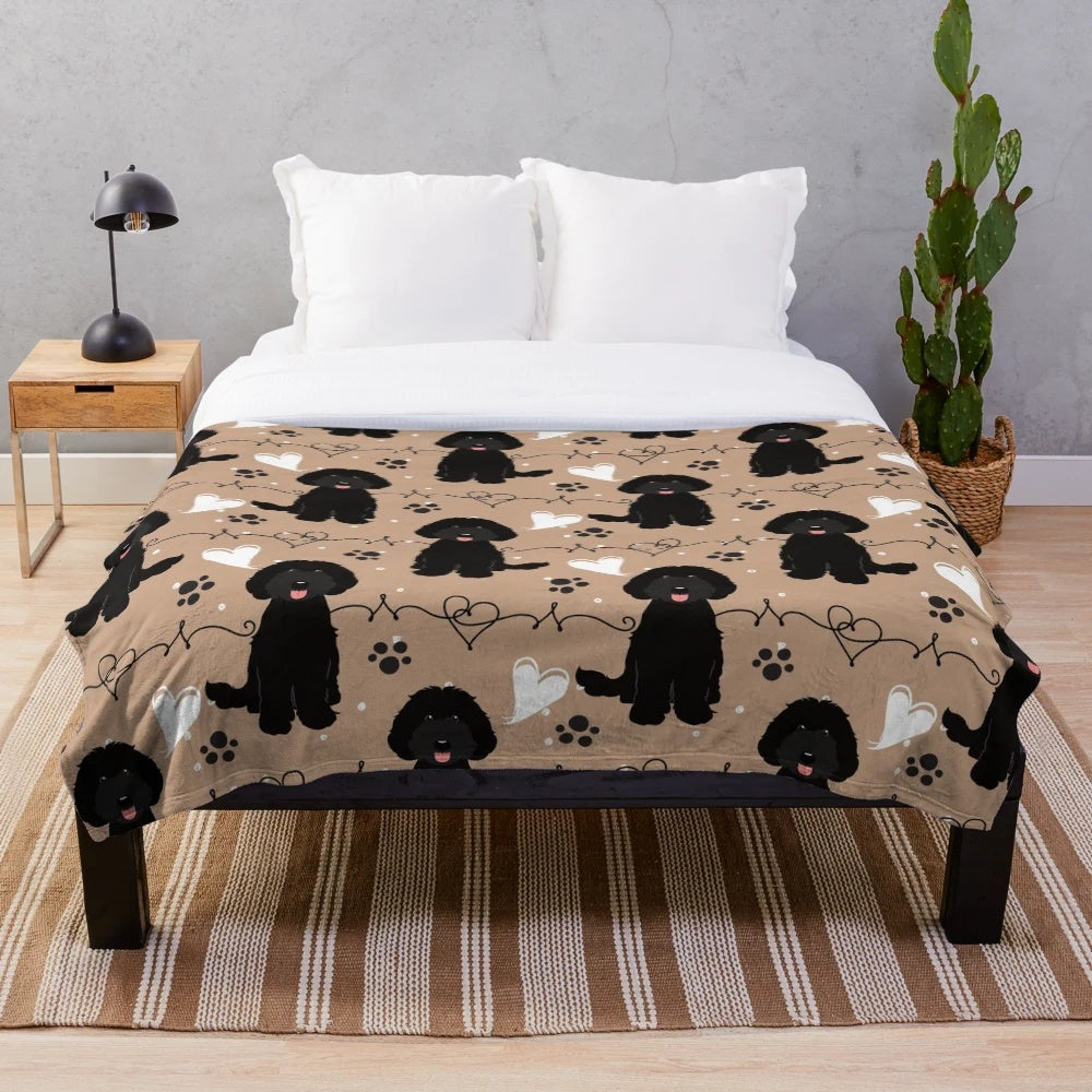 Black Labradoodle on a plush, cozy blanket