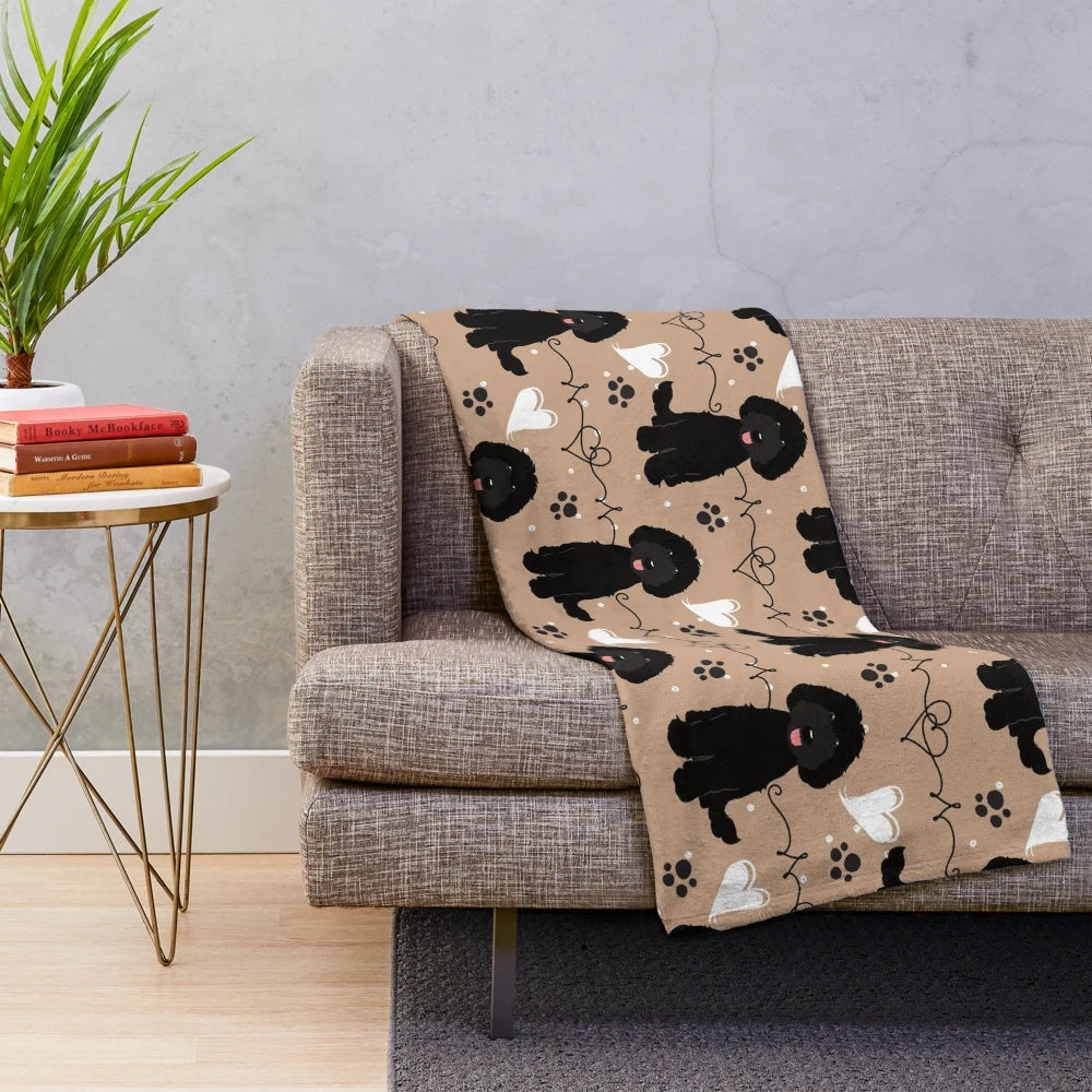Black Labradoodle on a plush, cozy blanket