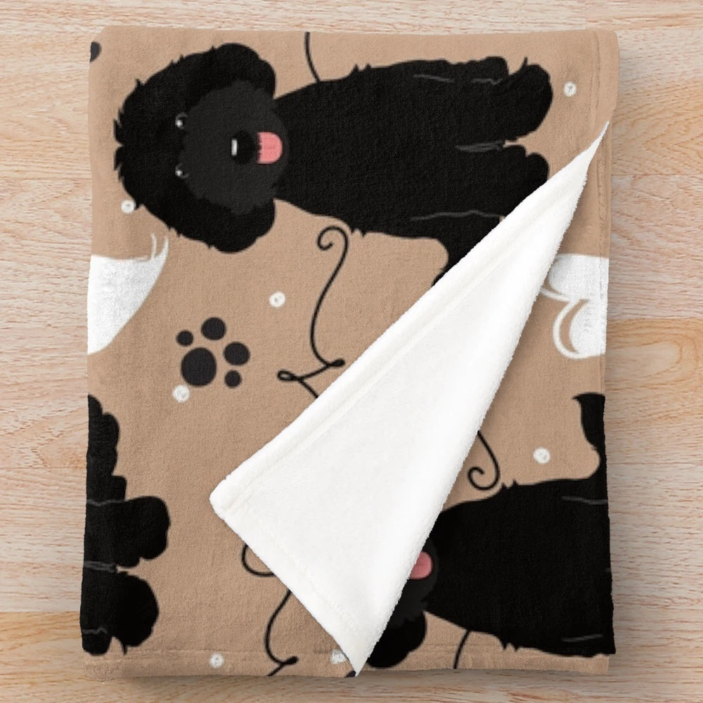 Black Labradoodle on a plush, cozy blanket