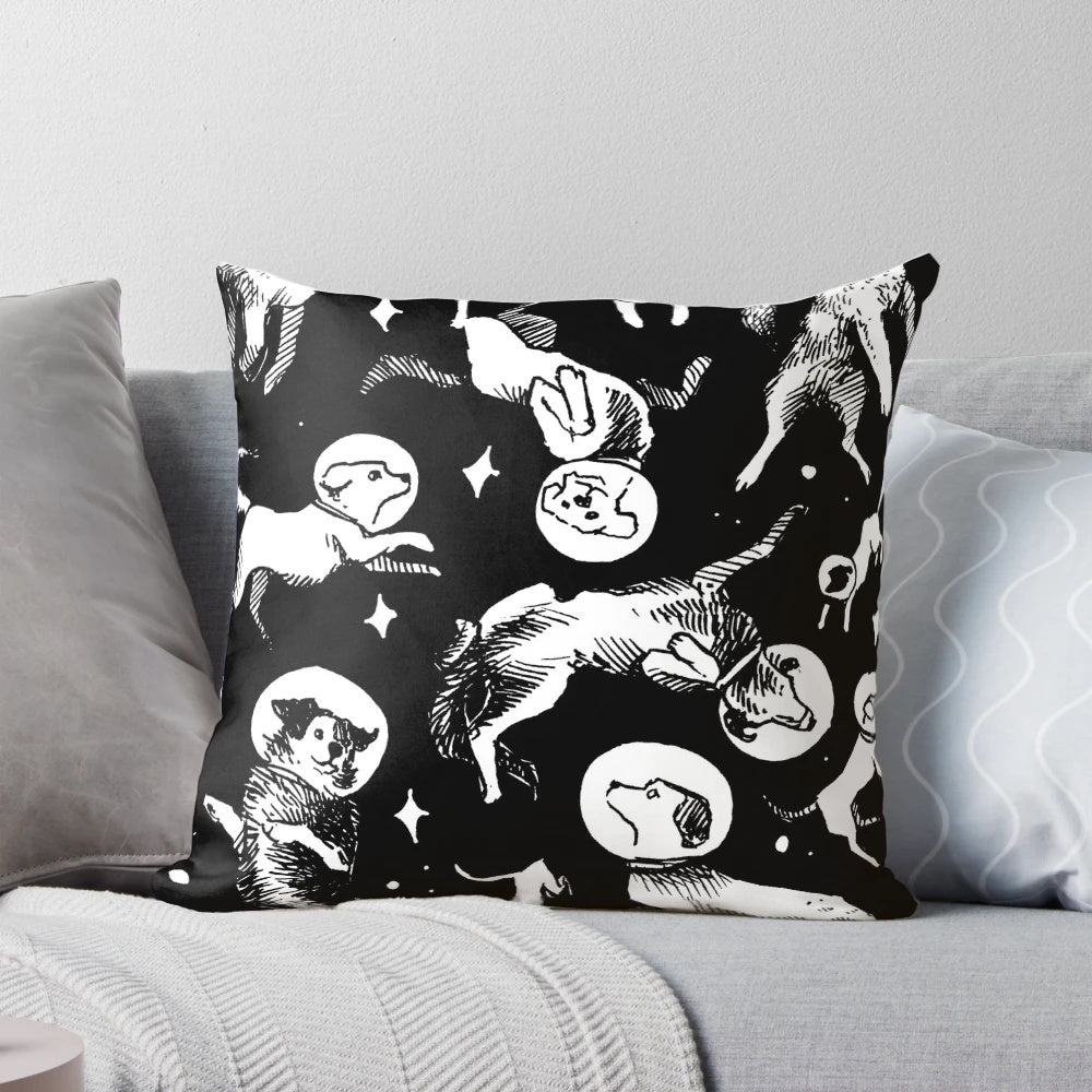 A plush pillow featuring a playful pattern of space-traveling dogs against a black background.