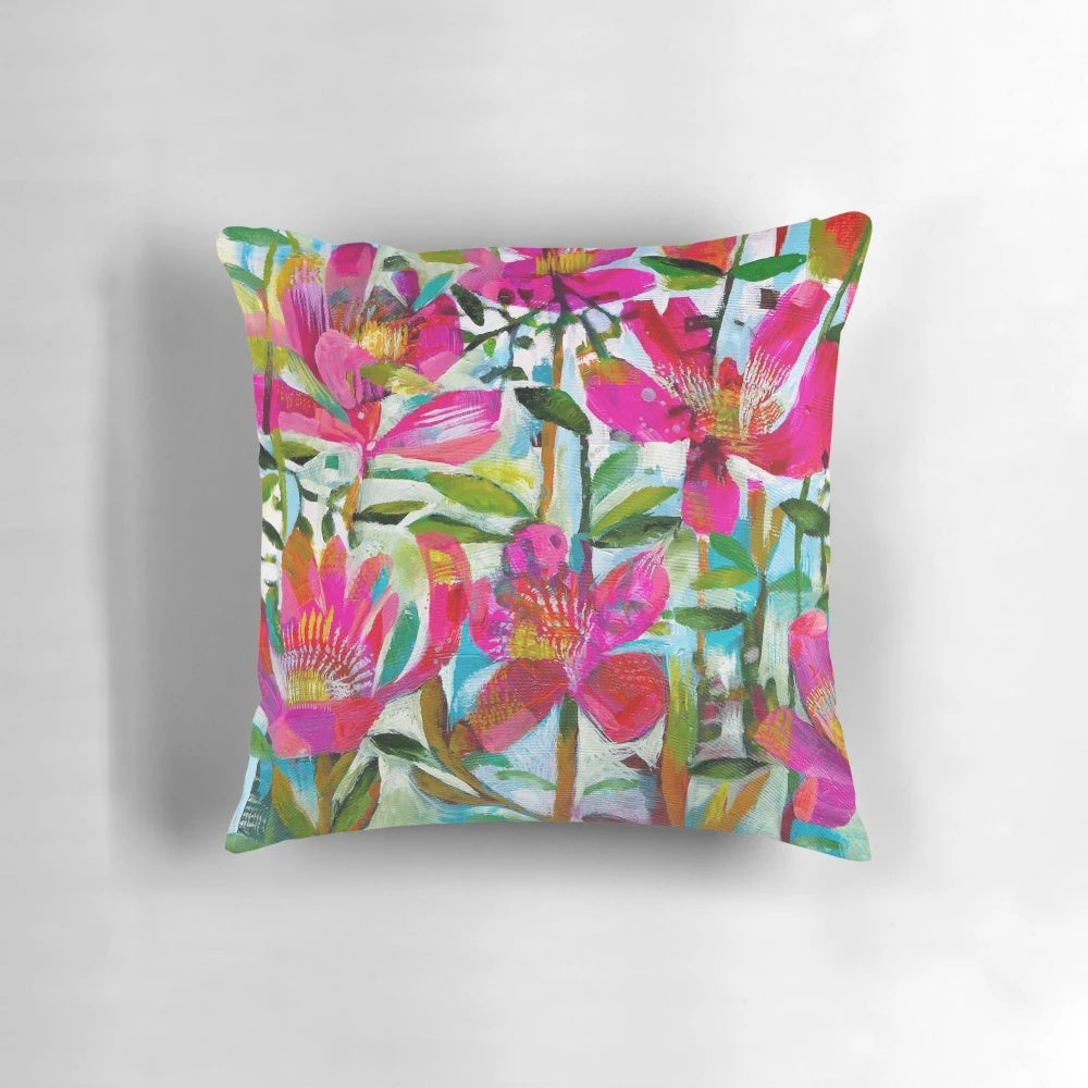 A vibrant and feminine floral pillow featuring a beautiful bouquet of summer roses in shades of pink.