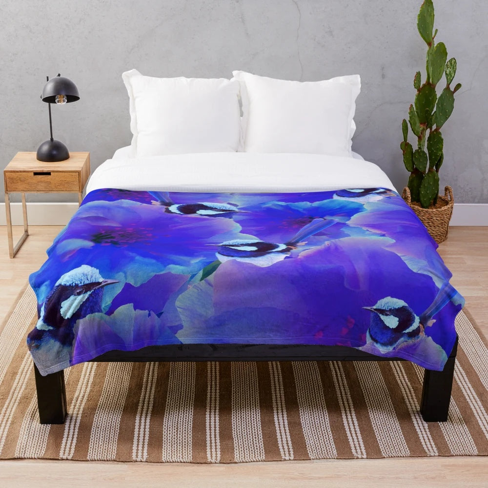 A beautiful plush blanket featuring a watercolor-style illustration of a blue wren bird perched among floral blossoms
