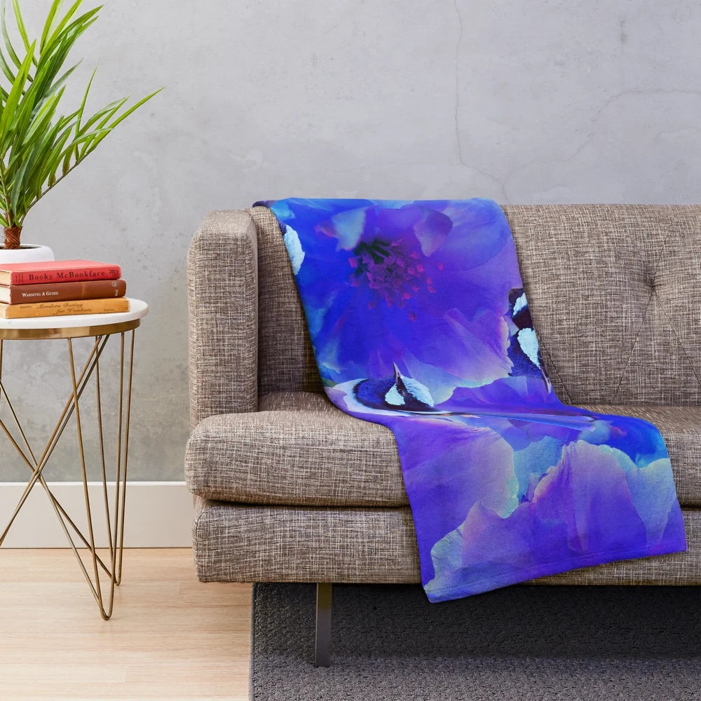 A beautiful plush blanket featuring a watercolor-style illustration of a blue wren bird perched among floral blossoms