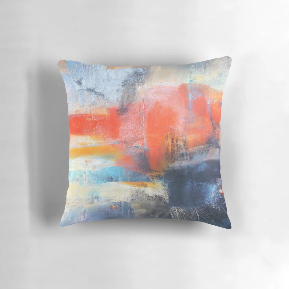 Blue and red abstract landscape painting on a large decorative throw pillow