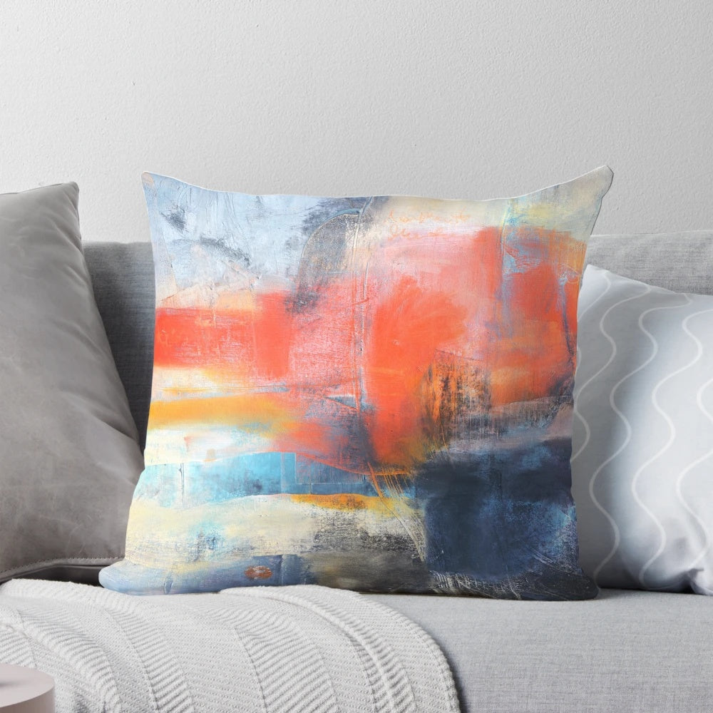 Blue and red abstract landscape painting on a large decorative throw pillow