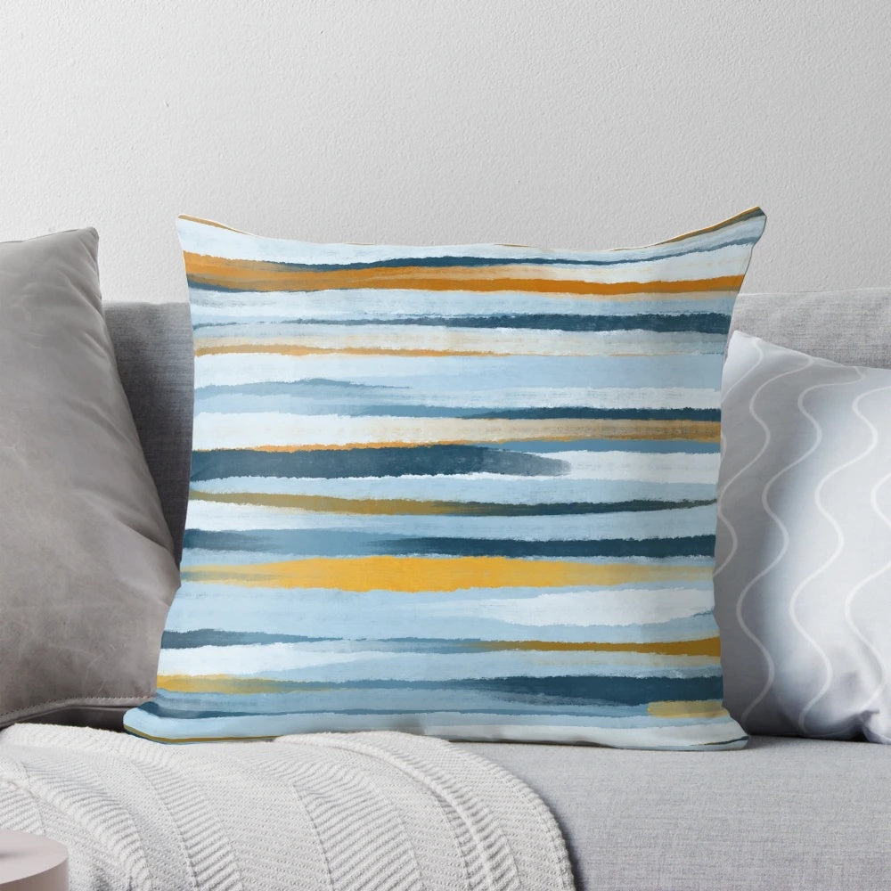 A blue and yellow minimalist throw pillow with abstract lines and geometric patterns