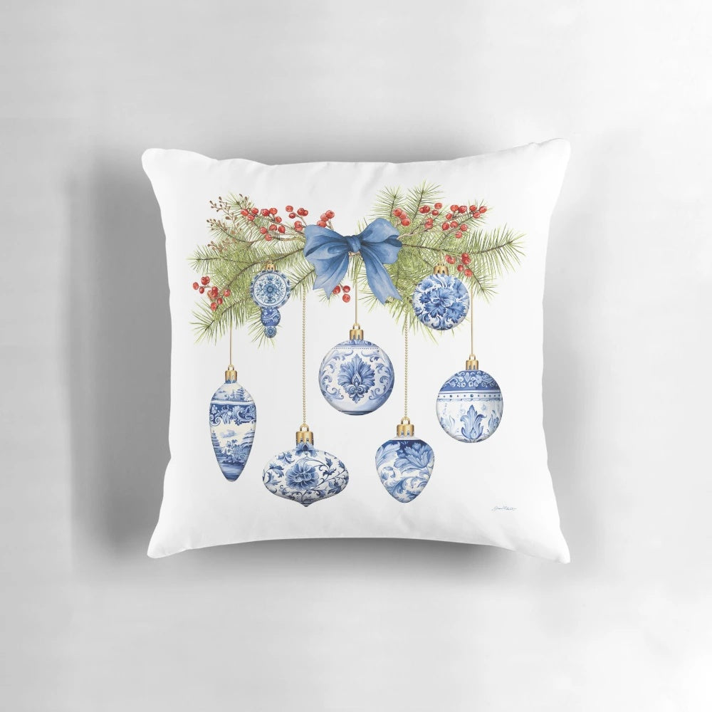 Blue chinoiserie-inspired decorative Christmas pillow with berries, pine branches, and bow