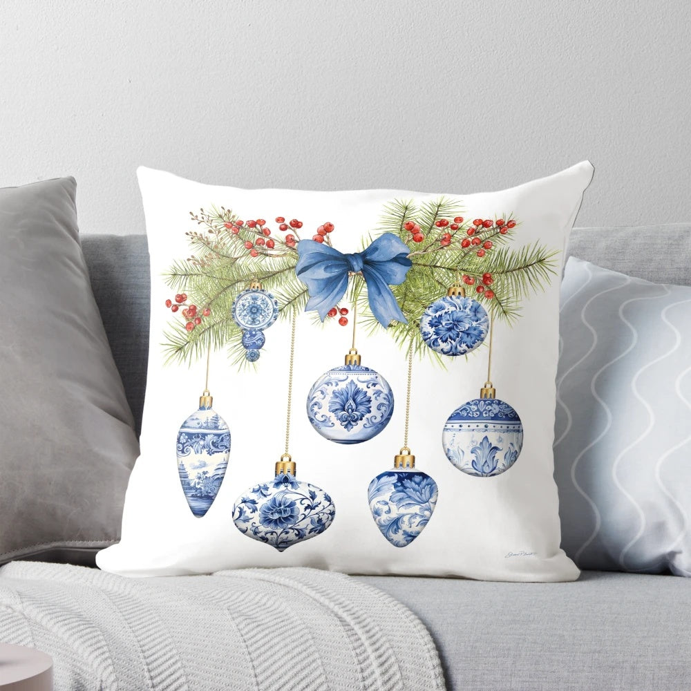 Blue chinoiserie-inspired decorative Christmas pillow with berries, pine branches, and bow