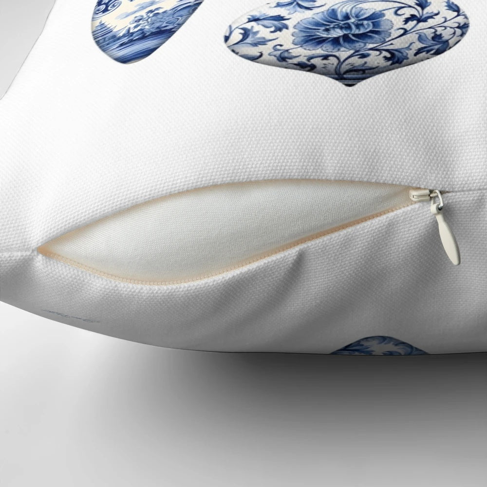 Blue chinoiserie-inspired decorative Christmas pillow with berries, pine branches, and bow