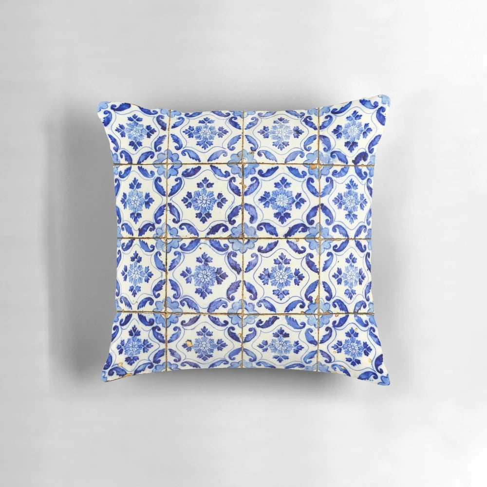 Blue and white floral patterned throw pillow with Portuguese tile design