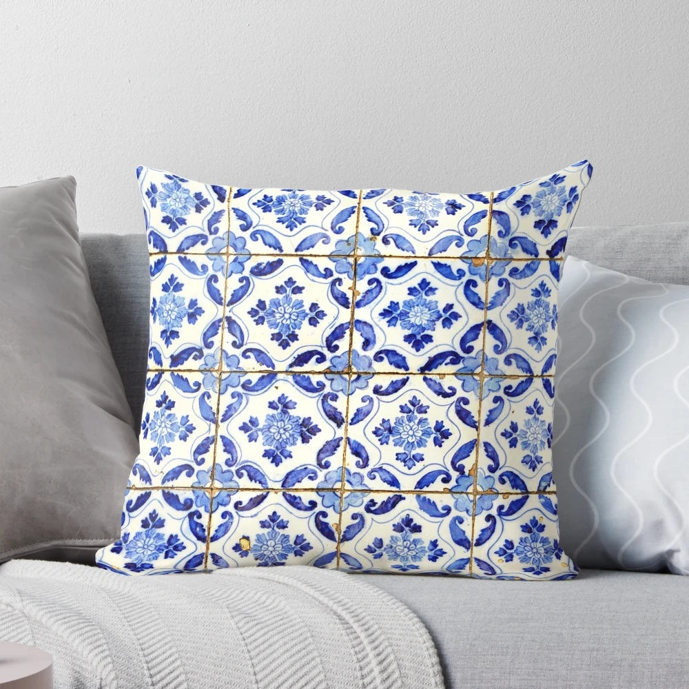 Blue and white floral patterned throw pillow with Portuguese tile design