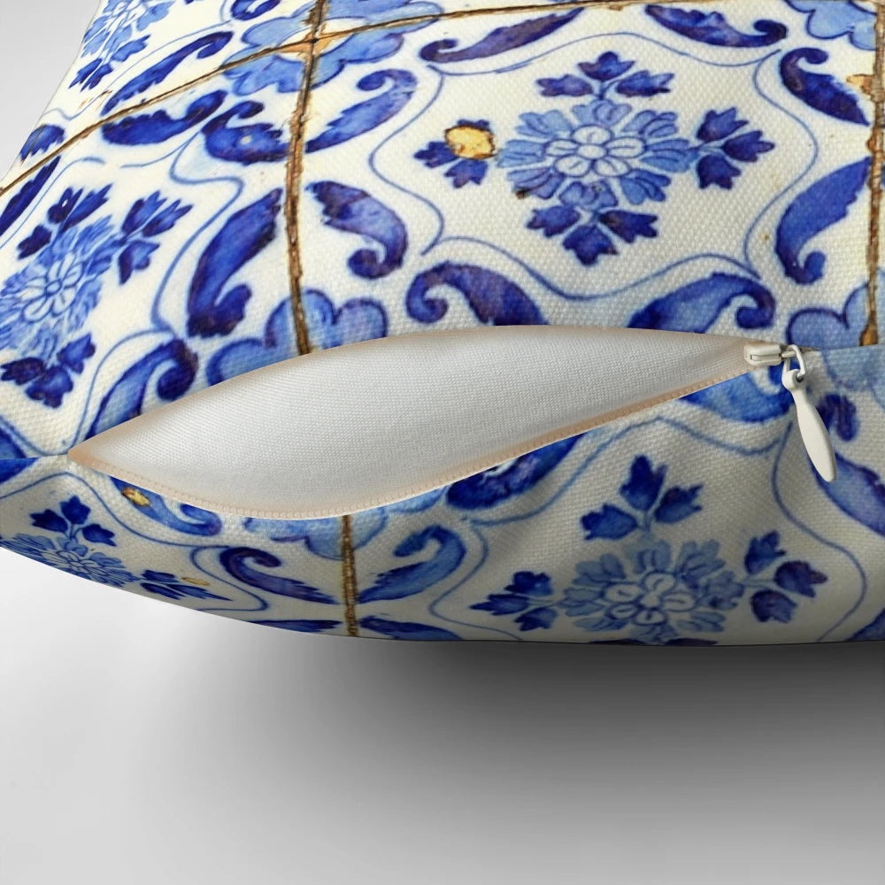 Blue and white floral patterned throw pillow with Portuguese tile design