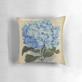 Blue hydrangea flowers printed on an aged, vintage book page, decorative pillow.