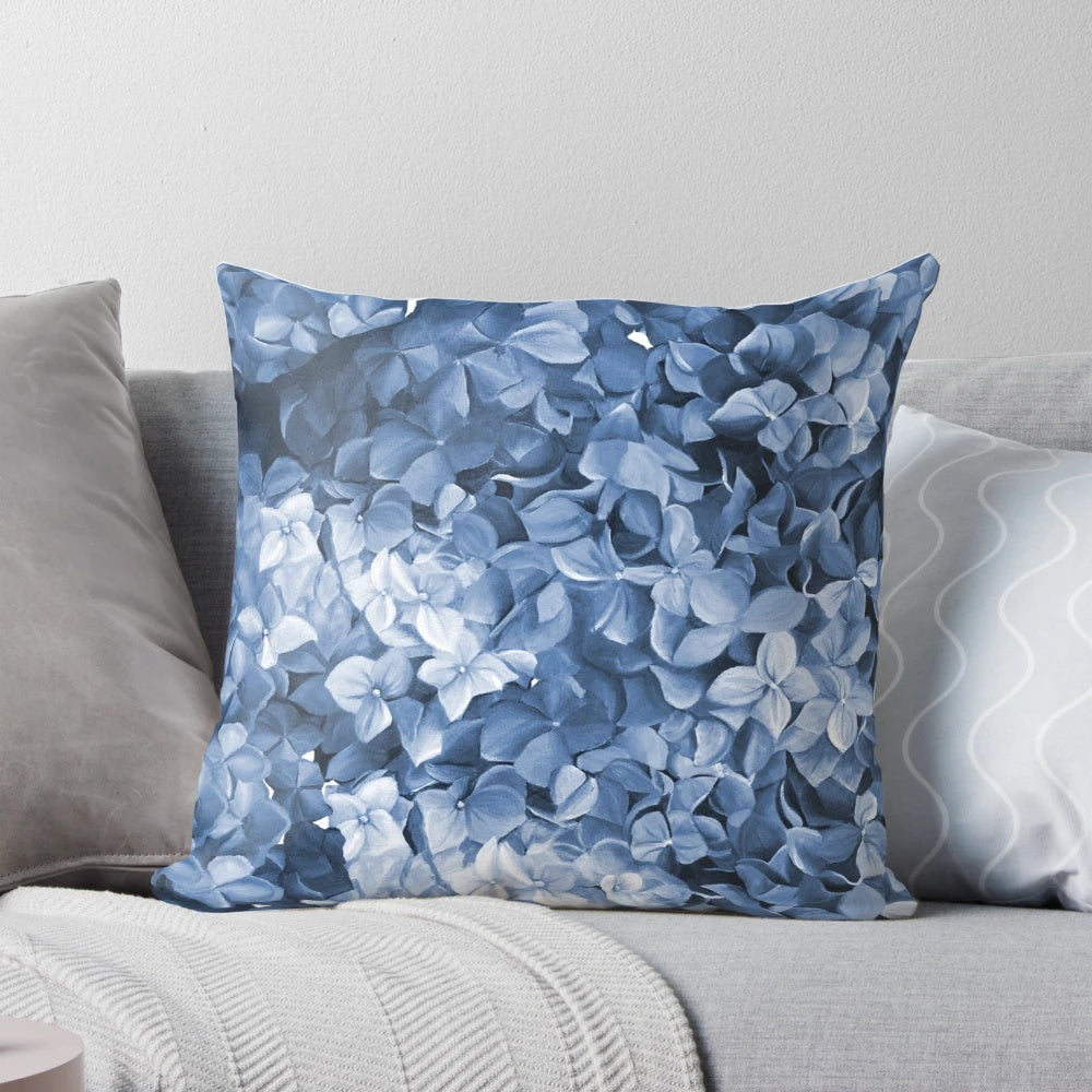 Vibrant blue hydrangea flowers in an oil painting-inspired design on a decorative pillow.
