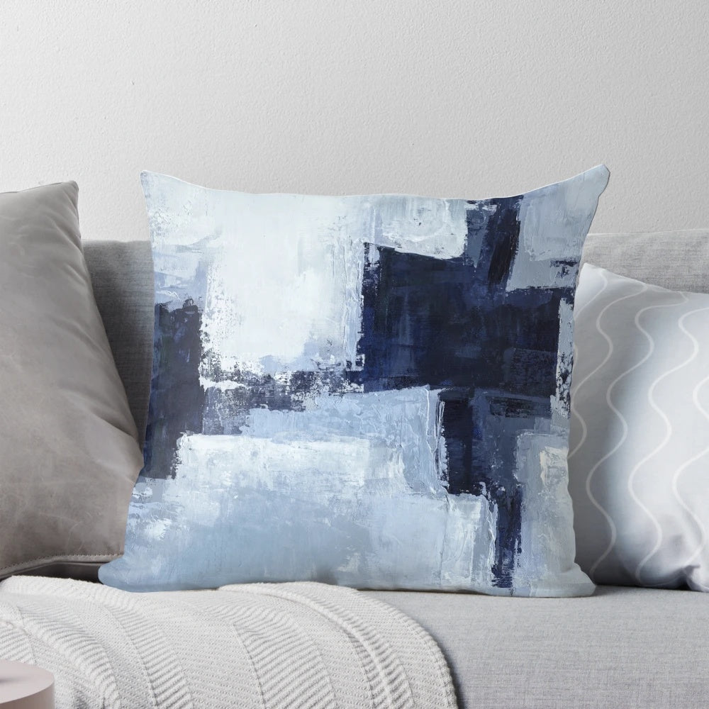 A set of two blue and navy abstract art pillows with a modern, minimalist design.
