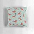 A colorful vintage-style pillow featuring a bluebird and floral pattern in shades of blue, orange, red, beige, and green.