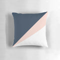 Blush pink and navy blue geometric triangle pillow with a minimalist, modern design