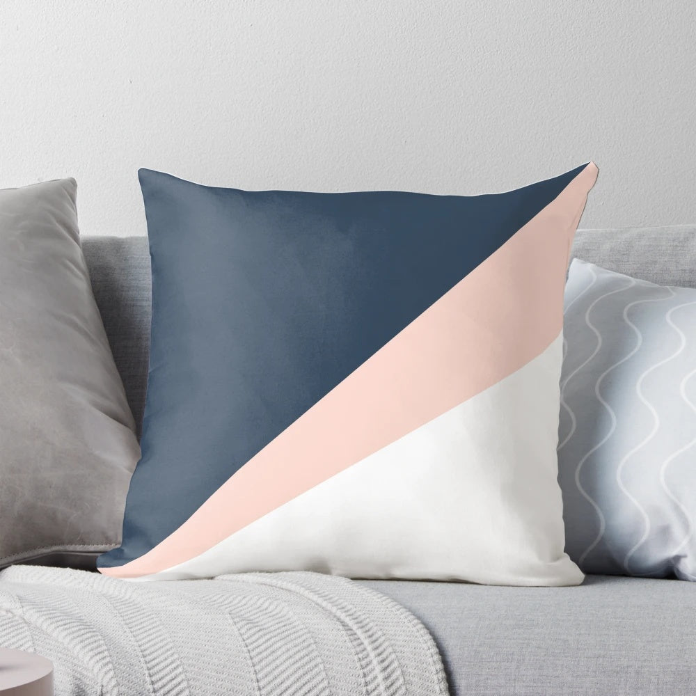 Blush pink and navy blue geometric triangle pillow with a minimalist, modern design