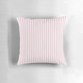 A decorative pillow with blush pink and white vertical stripes.