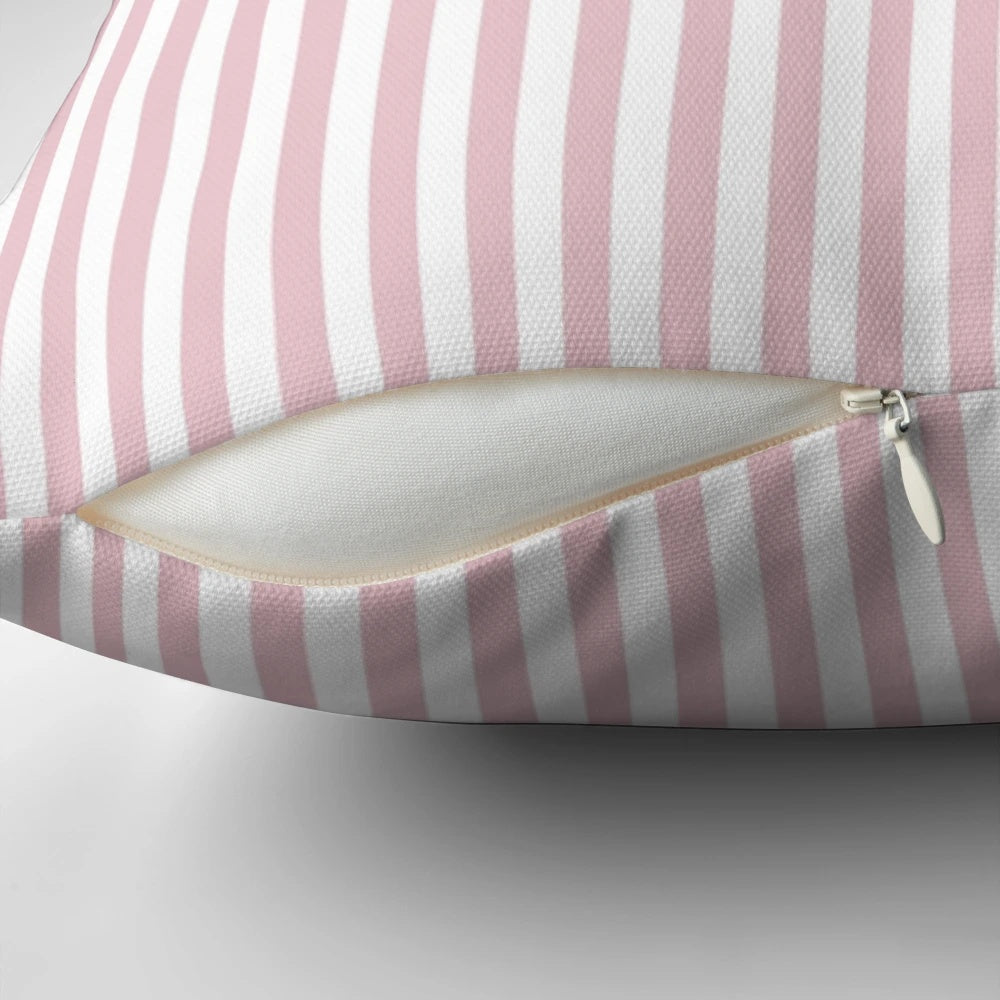 A decorative pillow with blush pink and white vertical stripes.