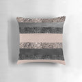 Closeup of a blush pink and grey striped decorative pillow with a glittery, luxurious texture.