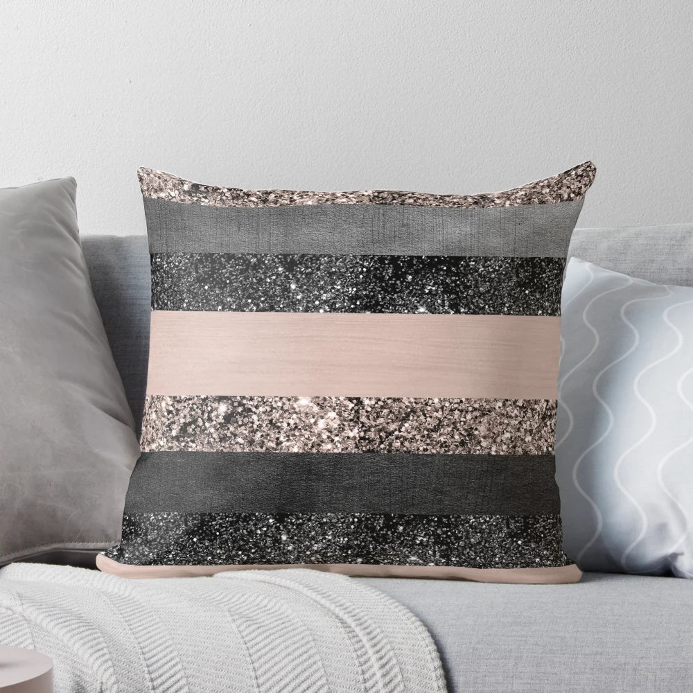 Closeup of a blush pink and grey striped decorative pillow with a glittery, luxurious texture.