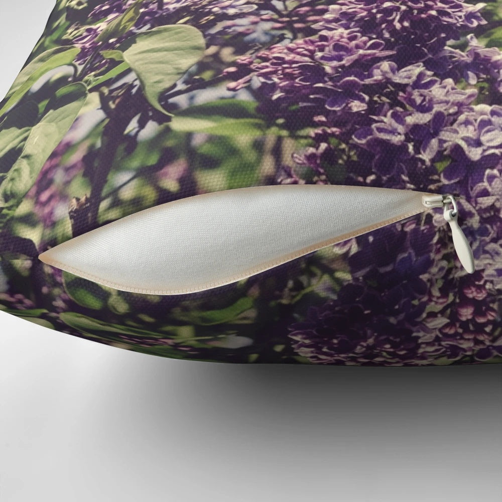 A Boho-style decorative pillow featuring vibrant purple lilacs and a minimalist design