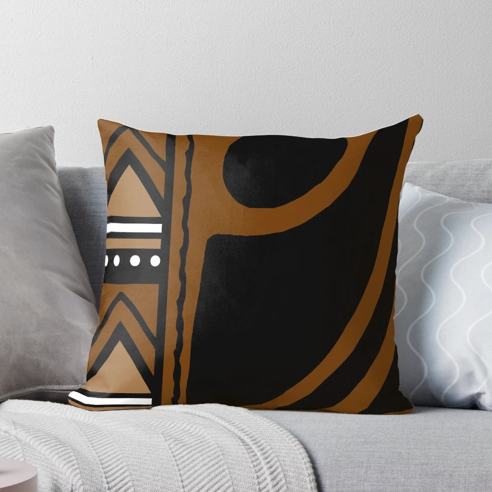 A modern throw pillow featuring an abstract African tribal mud cloth pattern in earth tones.